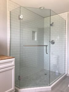 A Clear Glass Shower Cabinet With White Tiles